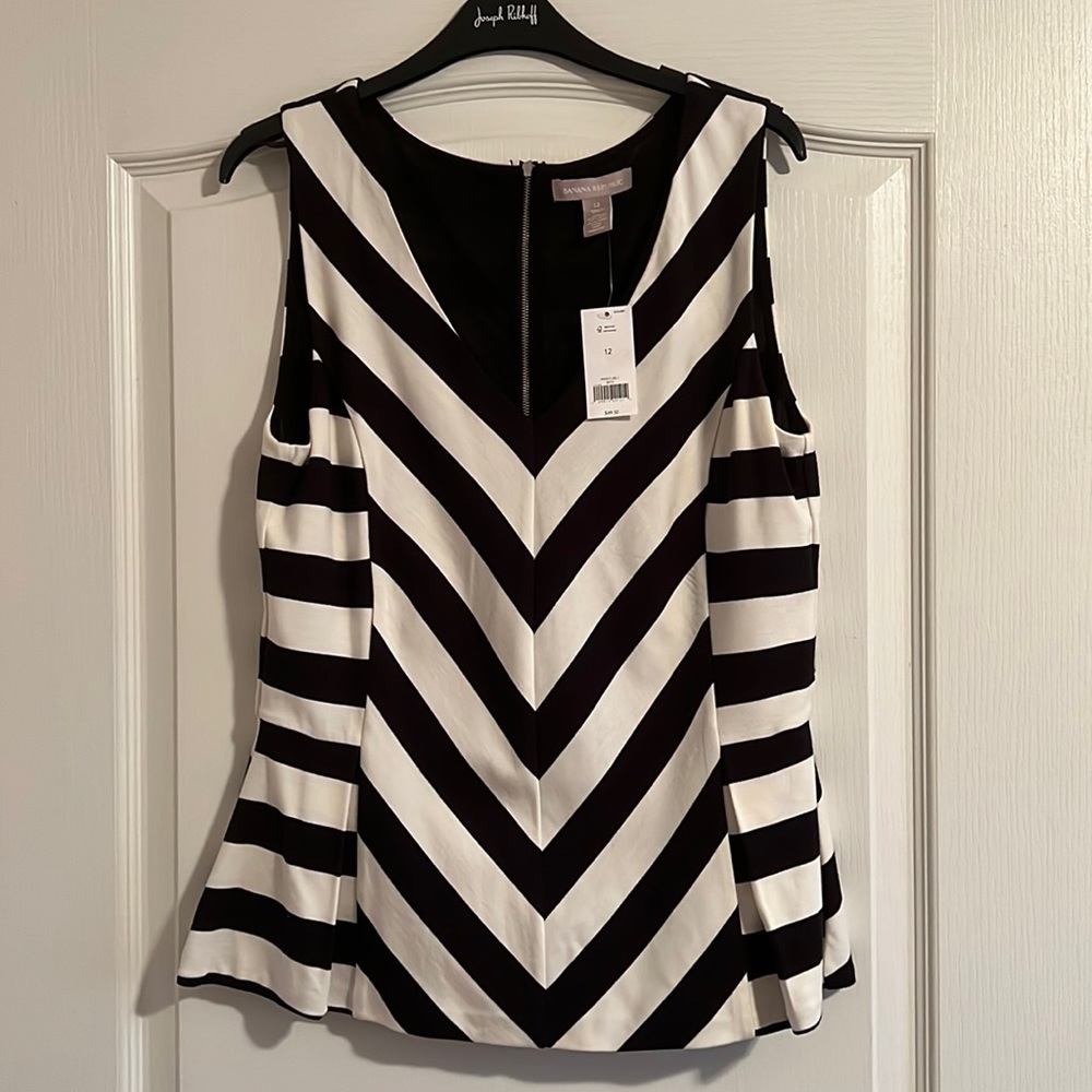 Sleeveless peplum top with black and white chevron pattern
